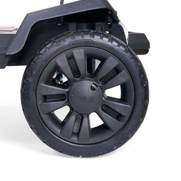 Close-up of a black wheel with tread pattern on a white background