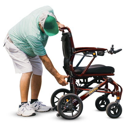 Person adjusting a folded wheelchair on a white background