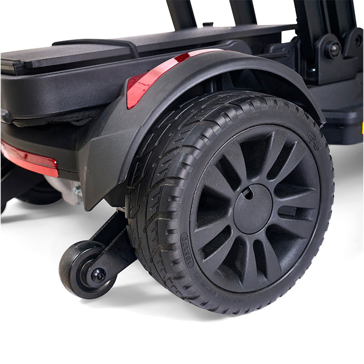 Close-up of a black wheel with red accents on a vehicle, likely a trailer or car carrier.