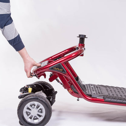 Red scooter with a person's hand holding onto it against a white background