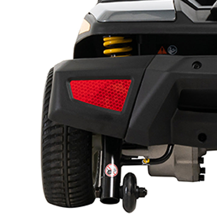 Close-up of a vehicle's rear bumper with a red reflector on a white background