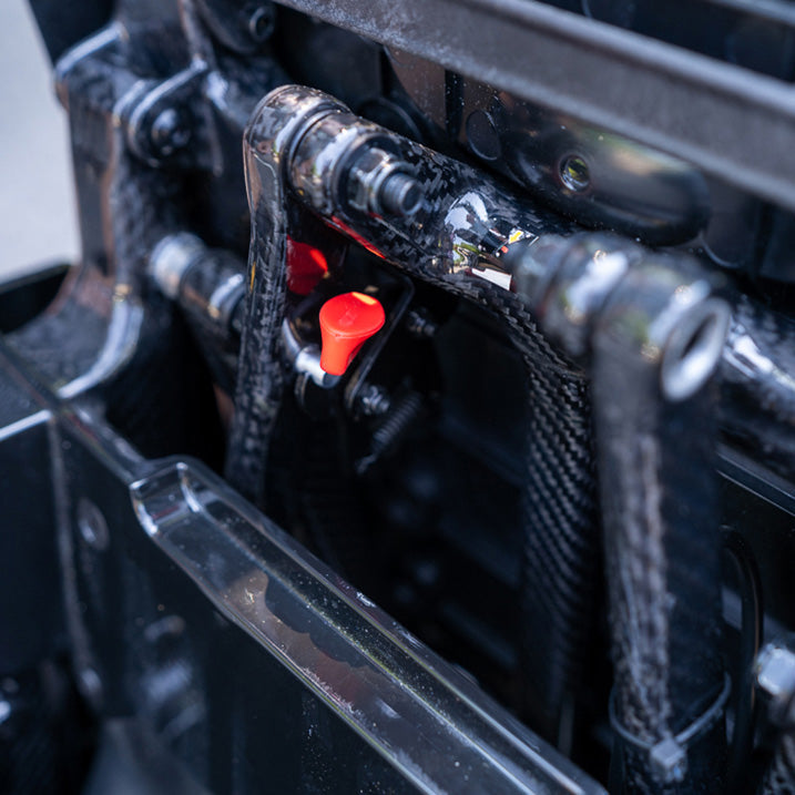 Close-up of a mechanical component with red buttons on a black background
