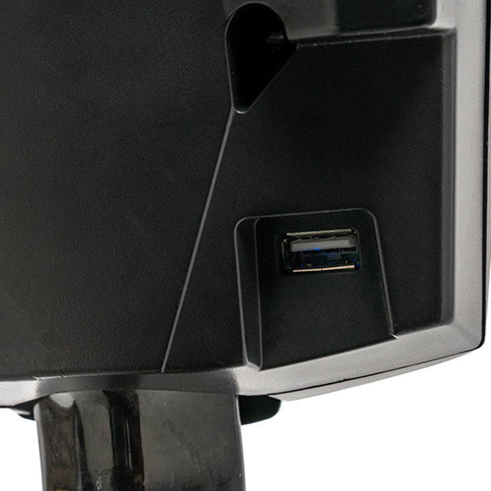 Close-up of a black electronic device with a USB port on a white background