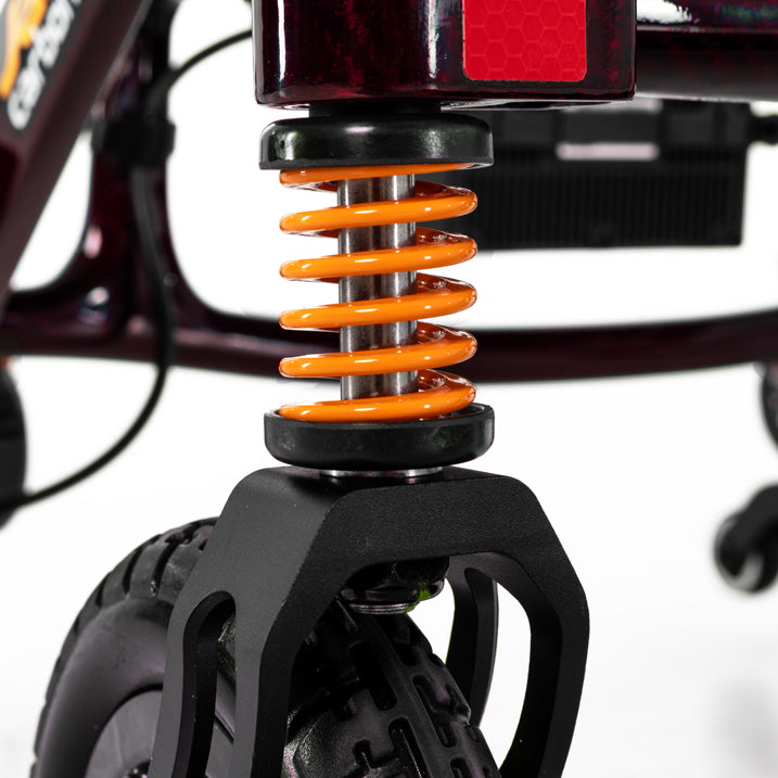 Close-up of a jazzy carbon HD fork with orange spring on a white background