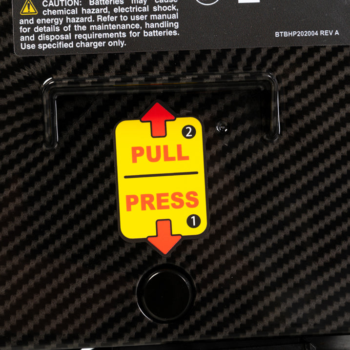 Yellow 'Pull Press' label on a black textured surface with warning text above.