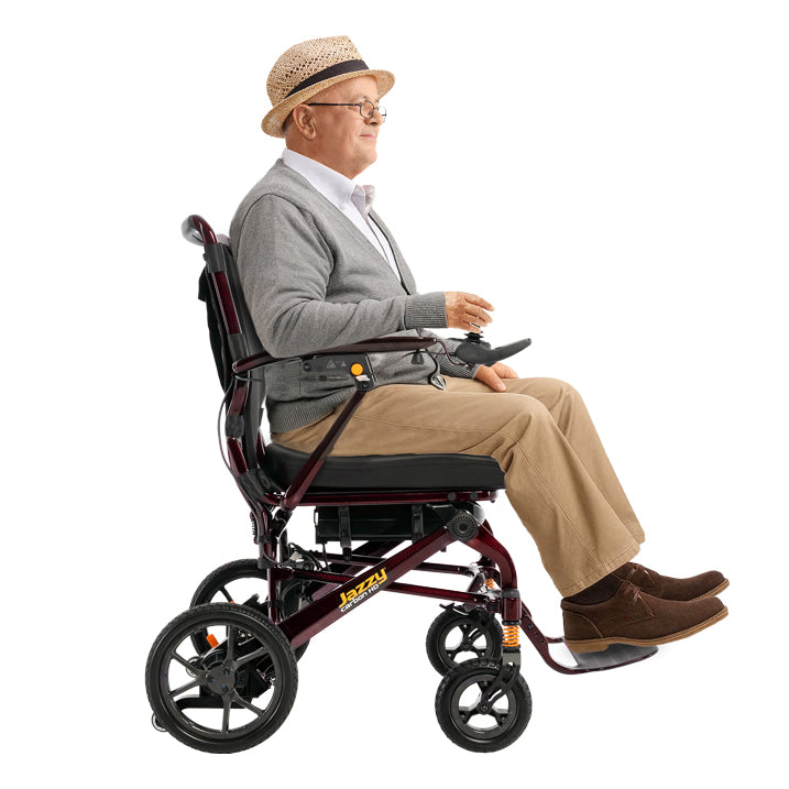 Man sitting in a Jazzy carbon HD  wearing a hat and glasses on a white background