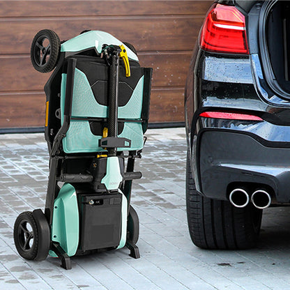 Mint pride go go super portable scooter attached to a car's hitch on a sidewalk.