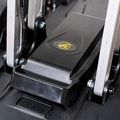 Close-up of a black foot pedal with a logo on a piece of exercise equipment.