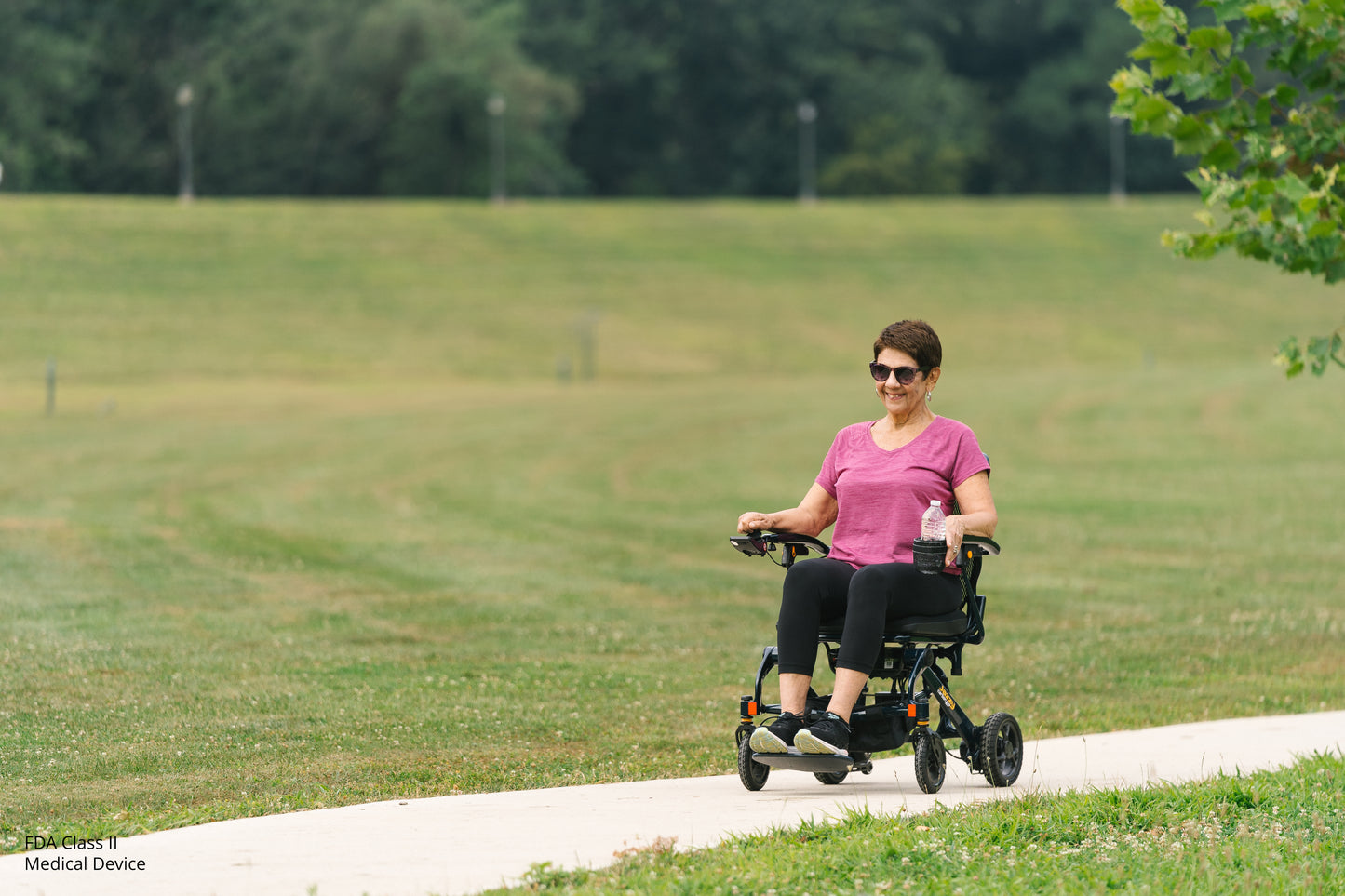 Person using a mobility scooter in a park setting