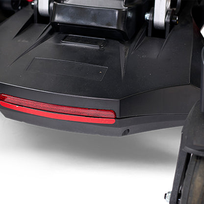 Close-up of a black scooter with a red reflector on a white background