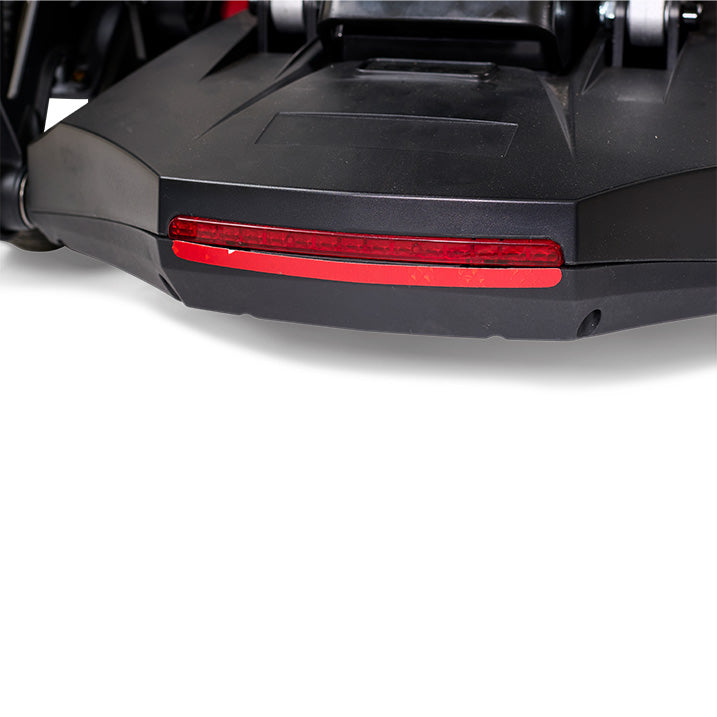 Close-up of a black scooter with a red reflector on a white background