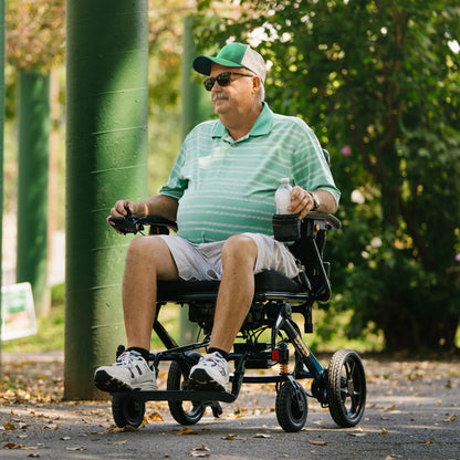 Man in a green shirt and cap using a Jazzy carbon HD 