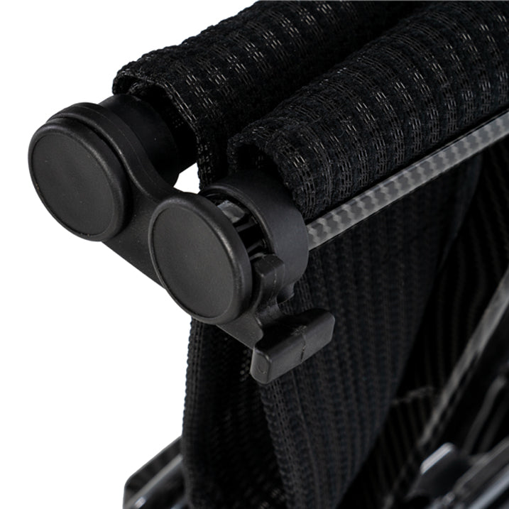 Close-up of a black folding chair with straps on a white background